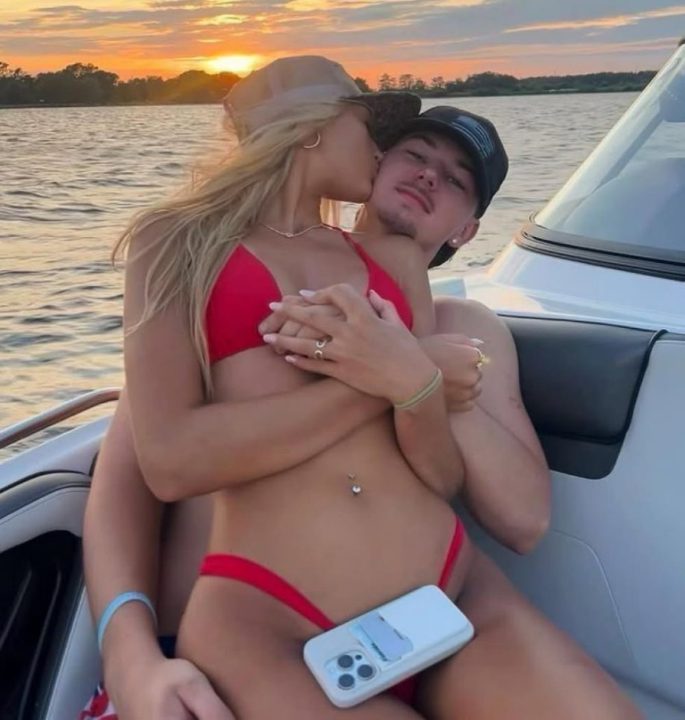 Couple on a boat at sunset enjoying private intimate moment for private sex chat privacy context
