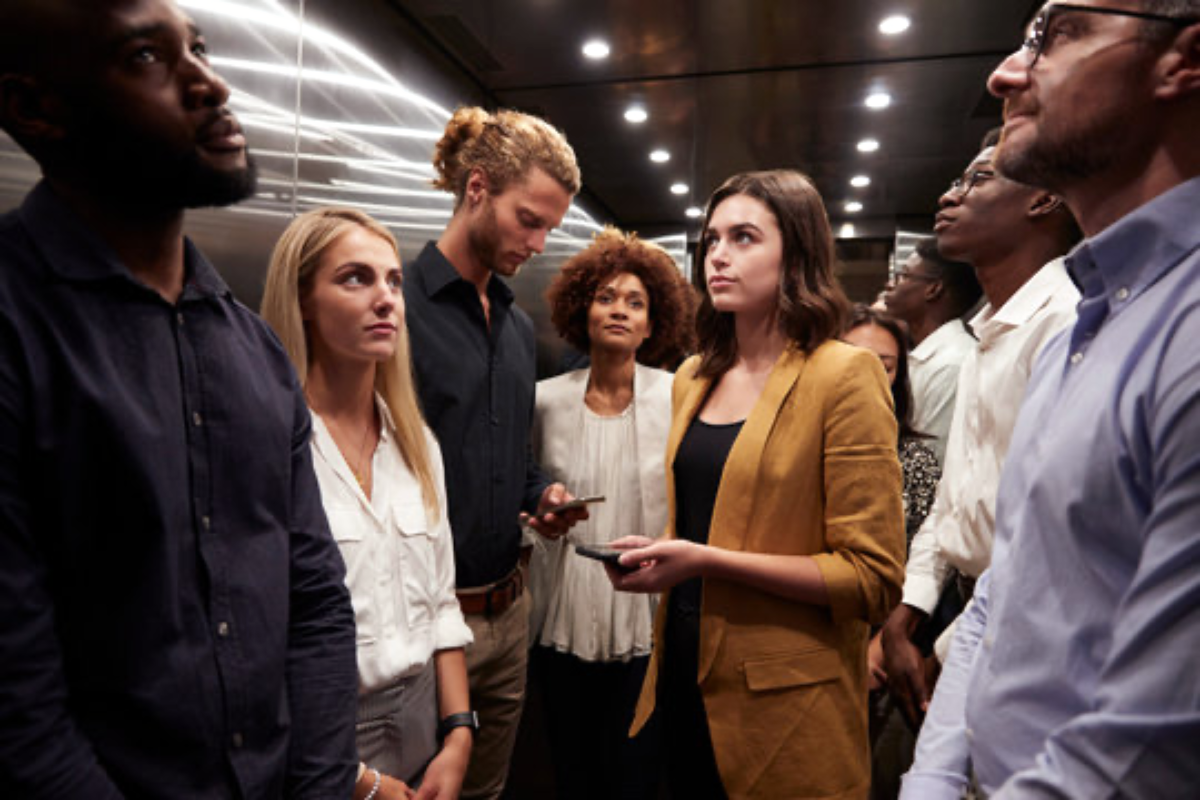 Office workers sharing an elevator before an unexpected online connection